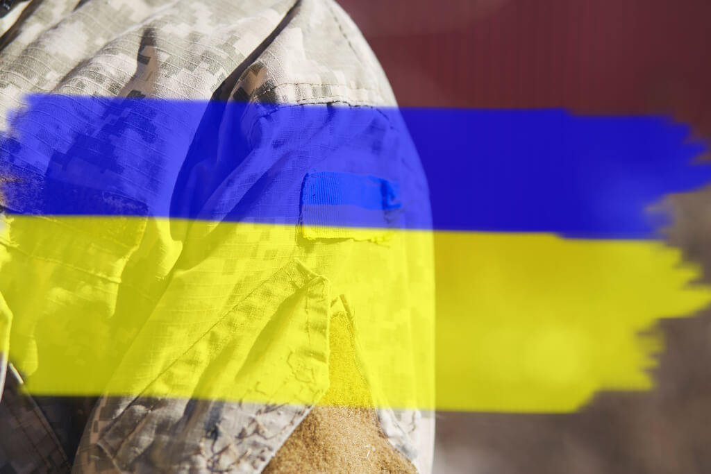 Ukrainian flag on military uniform. Ukrainian flag with copy space. Stop Russian aggression. Stop the war in Ukraine. Stay with Ukraine. Sensation. Pray for Ukraine