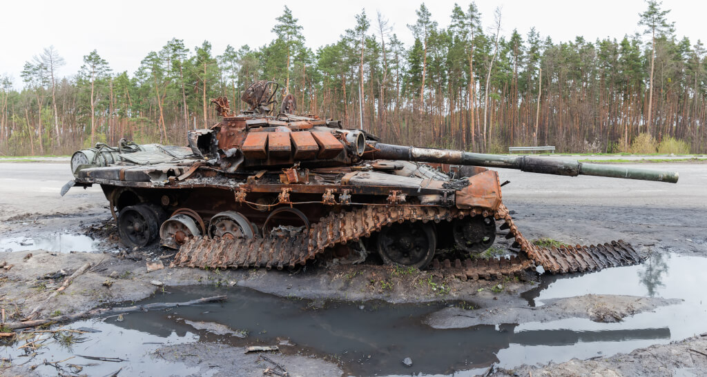 Russian battle tank which was destroyed on the roadside of highway during hostilities in Russian invasion of Ukraine, 2022, side panoramic view