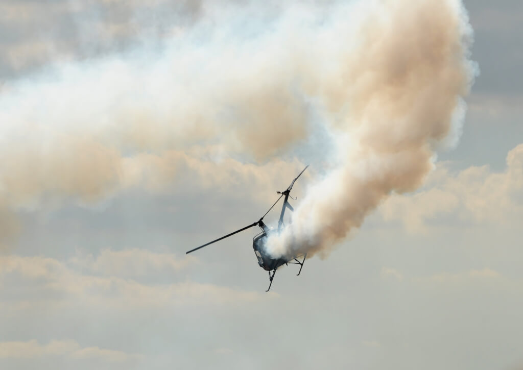 Small helicopter landing with engine fire