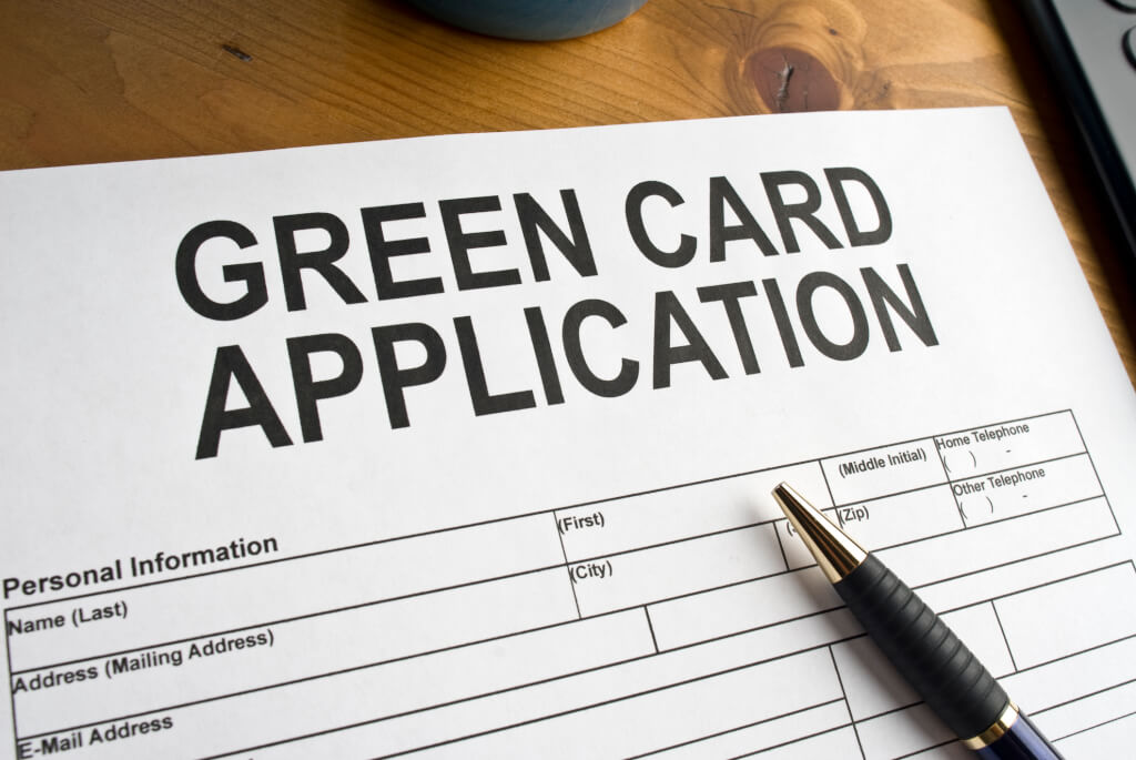 Application for a green card on a desk top.